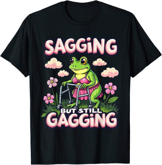 Sagging But Still Gagging — Green Bikini Frog — rude adult humour T-shirt from Rude Toad, black unisex tee. Design reads: SAGGING BUT STILL GAGGING